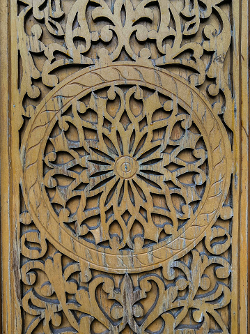 Traditional Central Asian floral ornament on an old wooden door