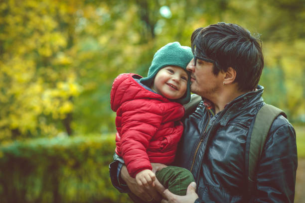istock Father and son in autumn park 1175449627