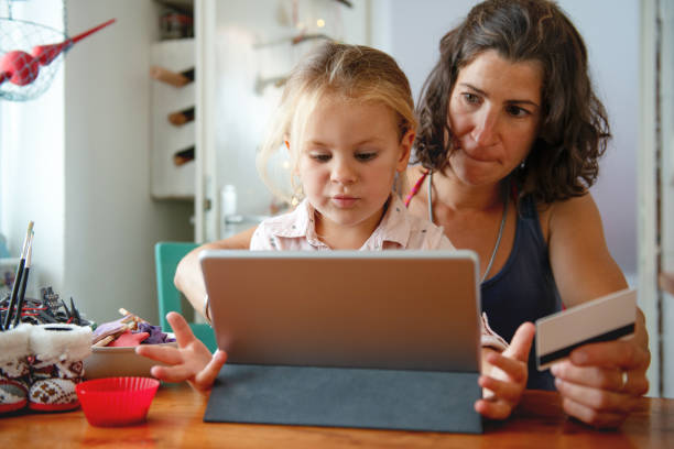 istock Mother paying with credit card from home 1175451798