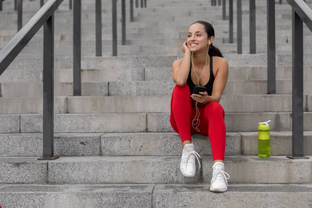 istock Young woman resting after jogging 1175453156
