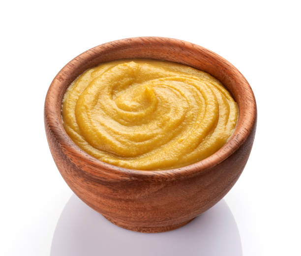 istock Mustard sauce in wooden bowl isolated on white background 1175453441