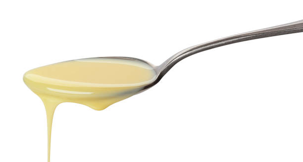 istock Pouring condensed milk isolated on white background 1175453509