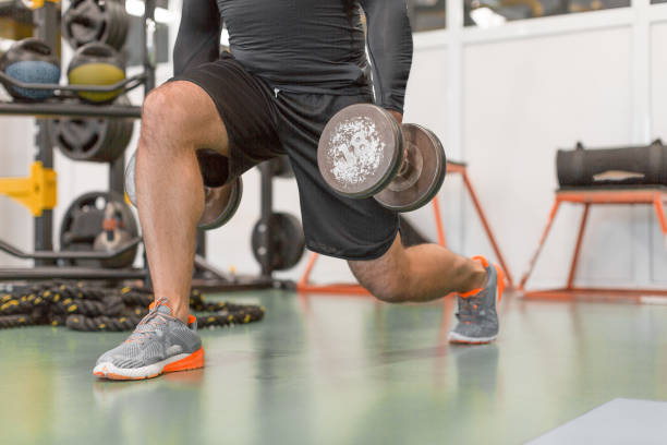 istock Cropped image of a man doing exercise for legs. Man working out legs with dumbbells. 1175453656