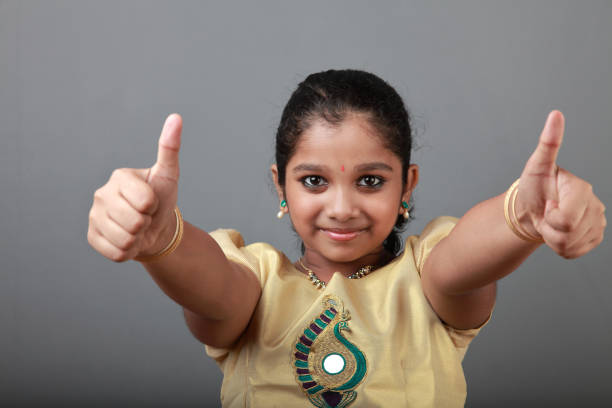 istock Happy little girls showing gestures 1175455035