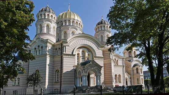 View on the Nativity of Christ Cathedral in Riga, Latvia with its sunny golden domes shining in the sun. It was built in a Neo-Byzantine style and is the largest Orthodox cathedral in the Baltic provinces.