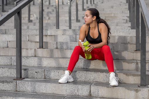 Young woman sitting after run