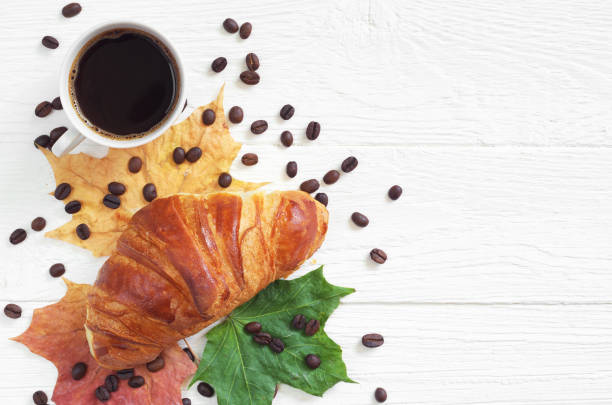 istock Coffee, croissant and leaves 1175455450