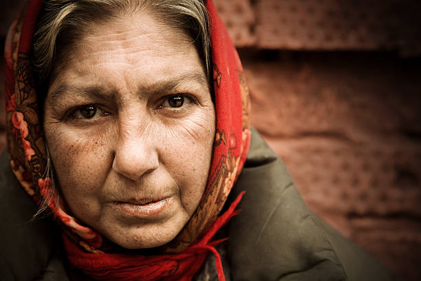 Elderly woman with a red headscarf stock photo