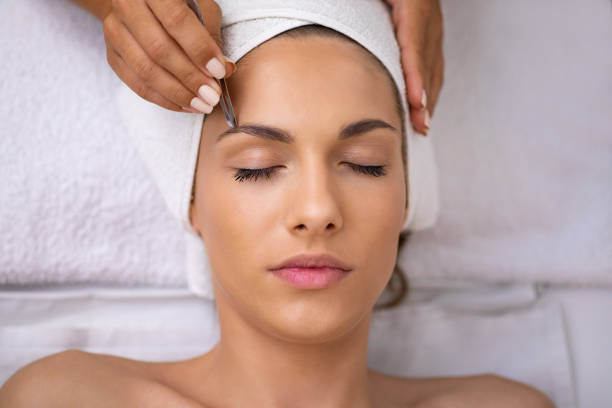Beautiful young woman gets eyebrow correction procedure
