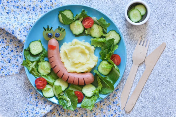 Funny kids lunch with mashed potatoes and sausage. Funny snail.