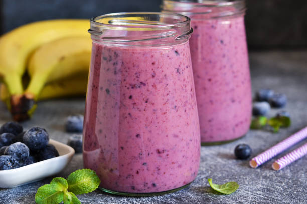 purple smoothies with blueberries on the kitchen table. detox menu. - blueberry smoothie milk shake drink imagens e fotografias de stock