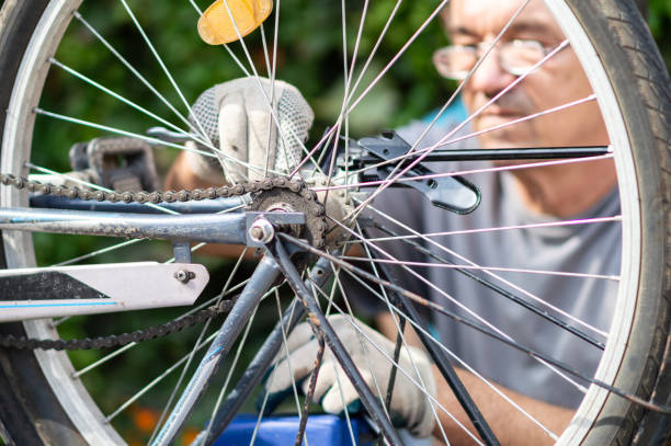 istock Hobby mechanic in overall repairs a bicycle 1175459189