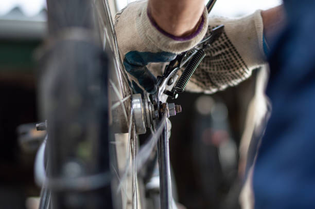 istock Hobby mechanic in overall repairs a bicycle 1175459759