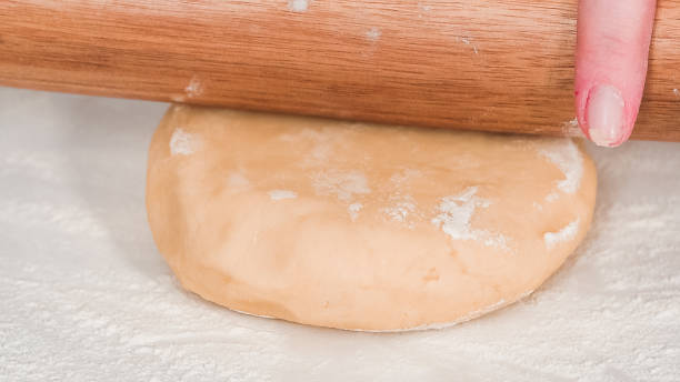 istock Rolling out Sugar cookie dough with French rolling pin 1175460840