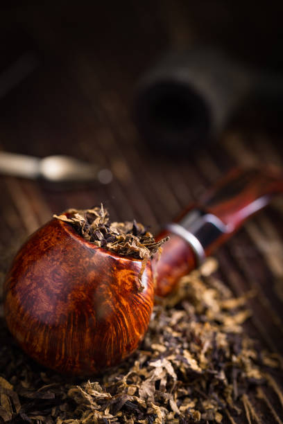 smoking pipe with tobacco leaves stock photo