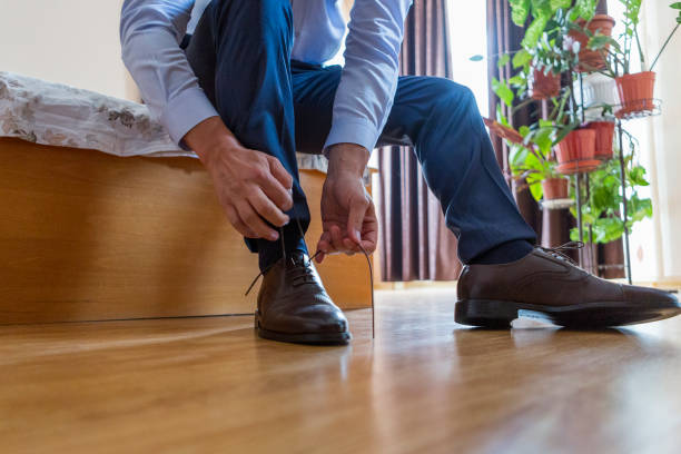 istock the groom puts on his wedding shoes. 1175461334