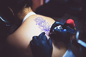 Professional Tattoo Artist Tattooing a Woman at his Studio - Bali, Indonesia