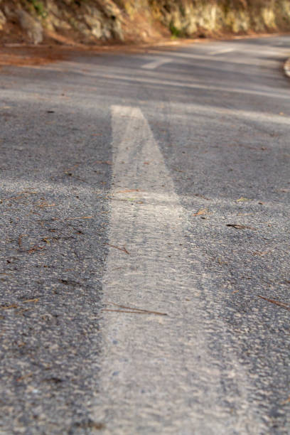 istock black asphalt road and white dividing lines 1175463212