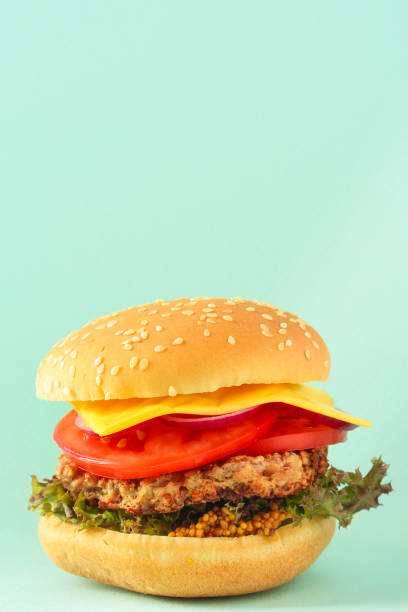 istock burger (roll, cutlets, cheese, lettuce, tomato, onion, sauce and more) menu concept. food background. copy space. Top view 1175464379