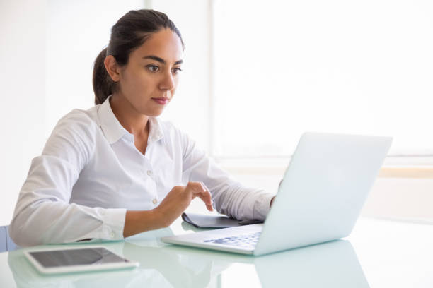 istock Serious focused businesswoman working on computer in office 1175464726