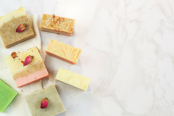 istock handmade multicolored soap with herbs and rosebuds, comb, towel, mirror, face brush on a marble background with. Spa eco friendly set kit for face and body treatments care flat lay instagram  style 1175465296