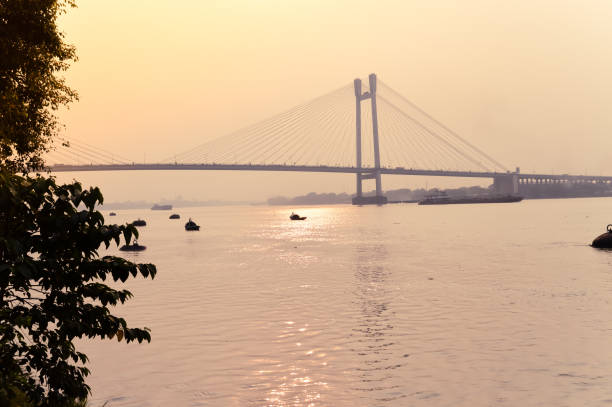 istock Sunset over Vidyasagar Setu (a Cantilever Spar Cable-Stayed Bridge) on the river Hooghly. 1175466292