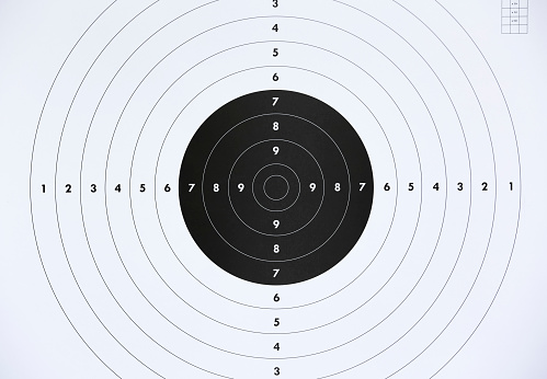 Close up of a paper target for shooting practice at shooting range. Crime or marketing concept.