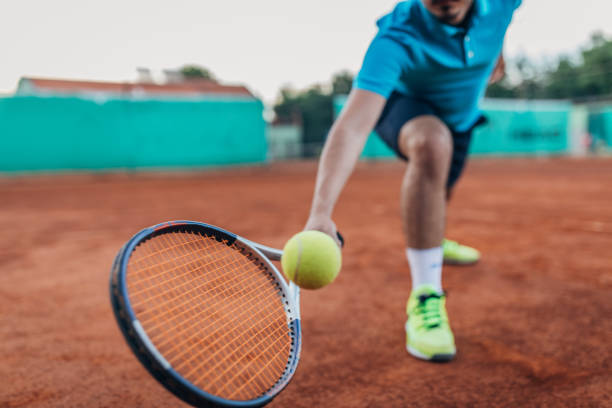istock Tennis player hitting a ball with a racket 1175468493