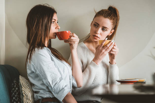 istock Young Female Friends is Having a Coffee Break 1175469662