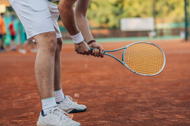 istock Tennis player holding a tennis racket on court 1175469708