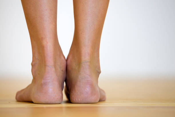 woman bare feet on the floor. legs care and skin treatment concept. - reflexology beauty naked human foot imagens e fotografias de stock