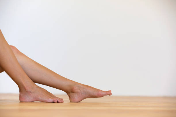woman bare feet on the floor. legs care and skin treatment concept. - reflexology beauty naked human foot imagens e fotografias de stock