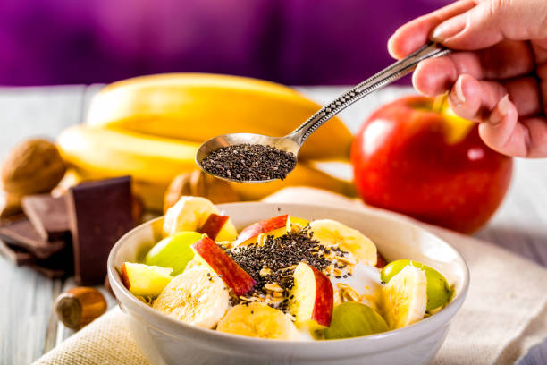 Bowl of cereal Healthy breakfast with yogurt, apple, banana and chia seeds. Bowl of fresh fruit. eating chia seeds stock pictures, royalty-free photos & images