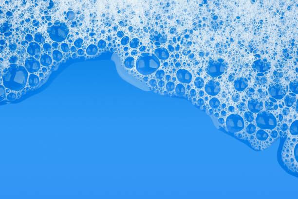 Bubble foam soap shampoo on blue water surface texture background top view Bubble foam soap shampoo on blue water surface texture background top view soap sud photos stock pictures, royalty-free photos & images