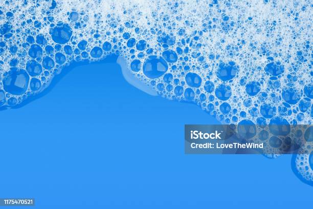 Bubble Foam Soap Shampoo On Blue Water Surface Texture Background Top View Stock Photo - Download Image Now