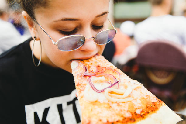 istock Young woman likes her pizza so much! 1175470667
