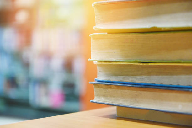 istock book stacked in library - education concept back to school and business study with old books on a wooden table 1175471496