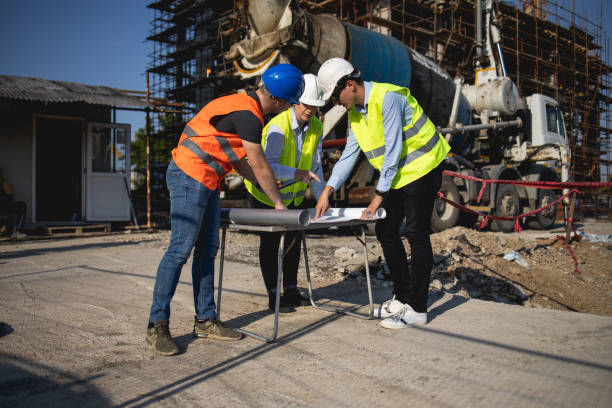istock Three construction workers having meeting,stock photo 1175471704