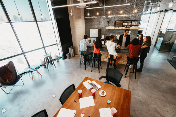 istock Wide angle shot of business people having coffee break at work 1175472350