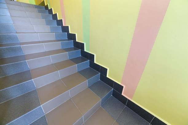 istock Wide staicase covered with ceramic tiles indoors in a house interior. 1175475674