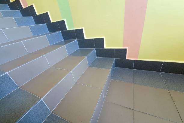 istock Wide staicase covered with ceramic tiles indoors in a house interior. 1175475690