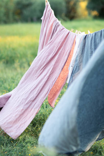 istock Clean bed sheet hanging on clothesline. 1175476002