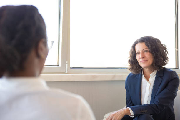 istock Female coworkers chatting in office lounge 1175476306
