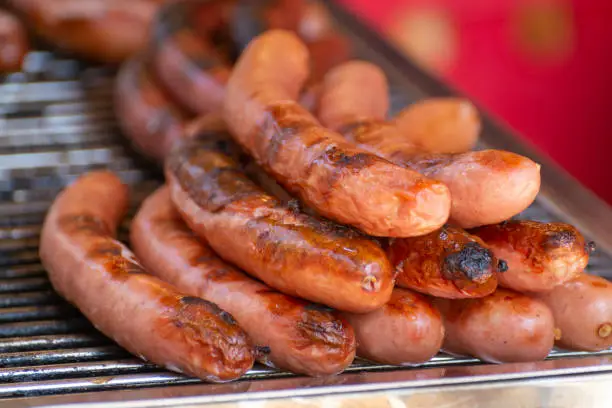 German streetfood, many BBQ grilled sausages ready to eat in outdoor cafe