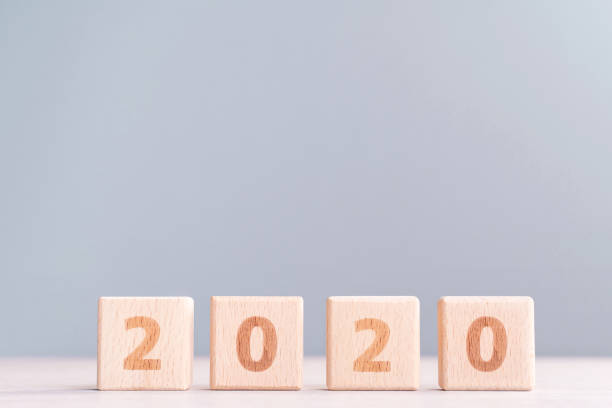 istock Abstract 2020 design concept - geometric wood blocks cubes on wooden table and low saturation gray blue background. 1175478529