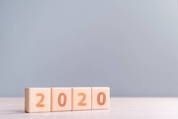 istock Abstract 2020 design concept - geometric wood blocks cubes on wooden table and low saturation gray blue background. 1175478549