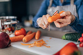 Lady peeling a carrot