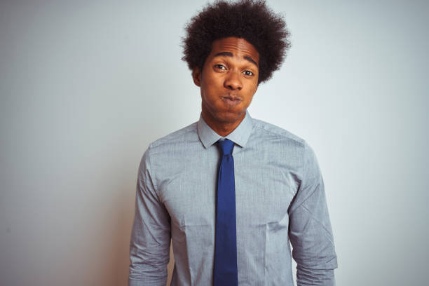 american business man with afro hair wearing shirt and tie over isolated white background puffing cheeks with funny face. mouth inflated with air, crazy expression. - full hair imagens e fotografias de stock