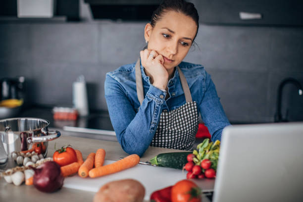 istock Lady looking for recipe online on laptop 1175484826