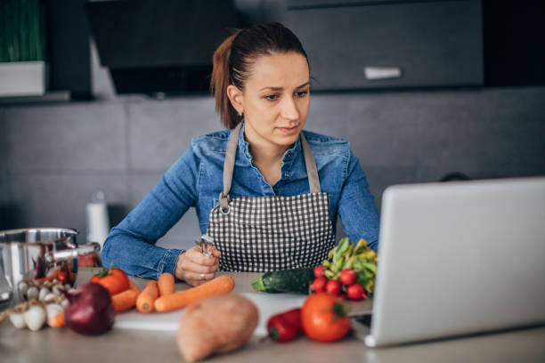 istock Lady looking for recipe on laptop 1175485132